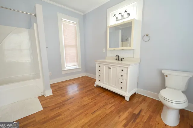 a bathroom with a toilet sink and a mirror