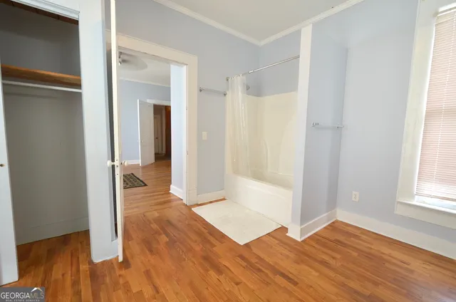 a view of a room with wooden floor and cabinet