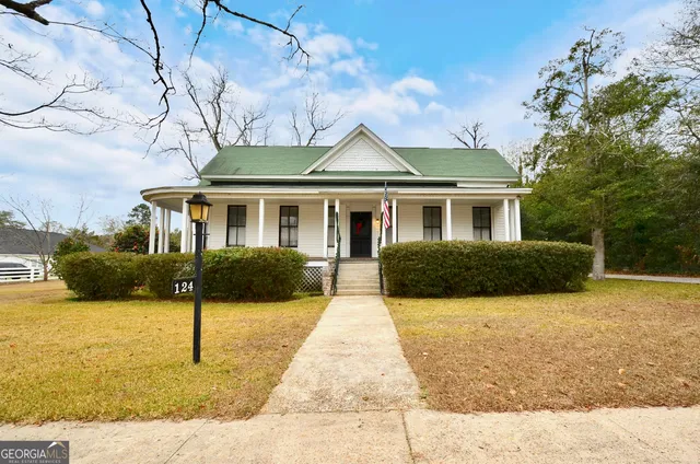 a front view of a house with yard and glass windows
