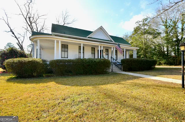 a front view of a house with a garden