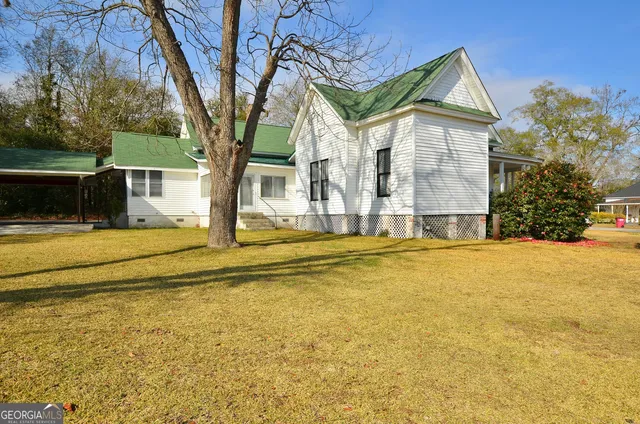 a house view with swimming pool in front of it