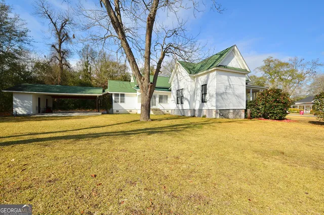 a view of a house with backyard porch and sitting area
