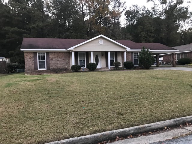 a front view of a house with garden