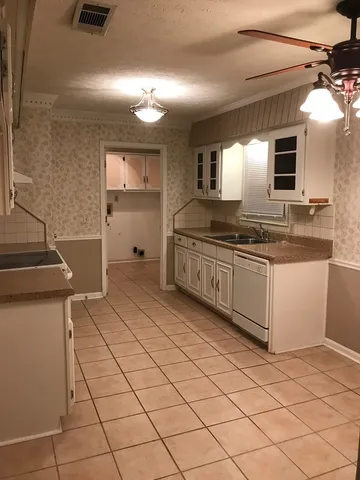 a bathroom with a granite countertop sink and mirror