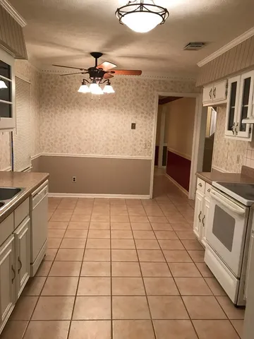 a kitchen with a stove top oven cabinets and stainless steel appliances