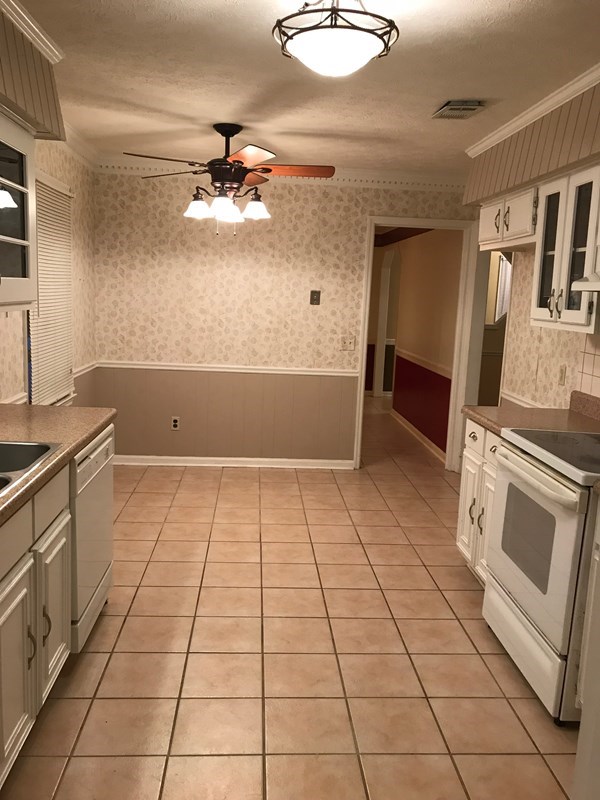 4109 Pickering Drive Columbus, GA 31907 - Photo 3 of 11 a kitchen with a stove top oven cabinets and stainless steel appliances