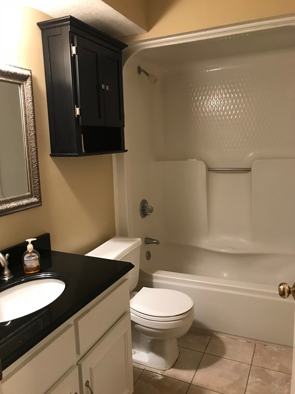 4109 Pickering Drive Columbus, GA 31907 - Photo 7 of 11 a bathroom with a granite countertop sink mirror vanity and toilet