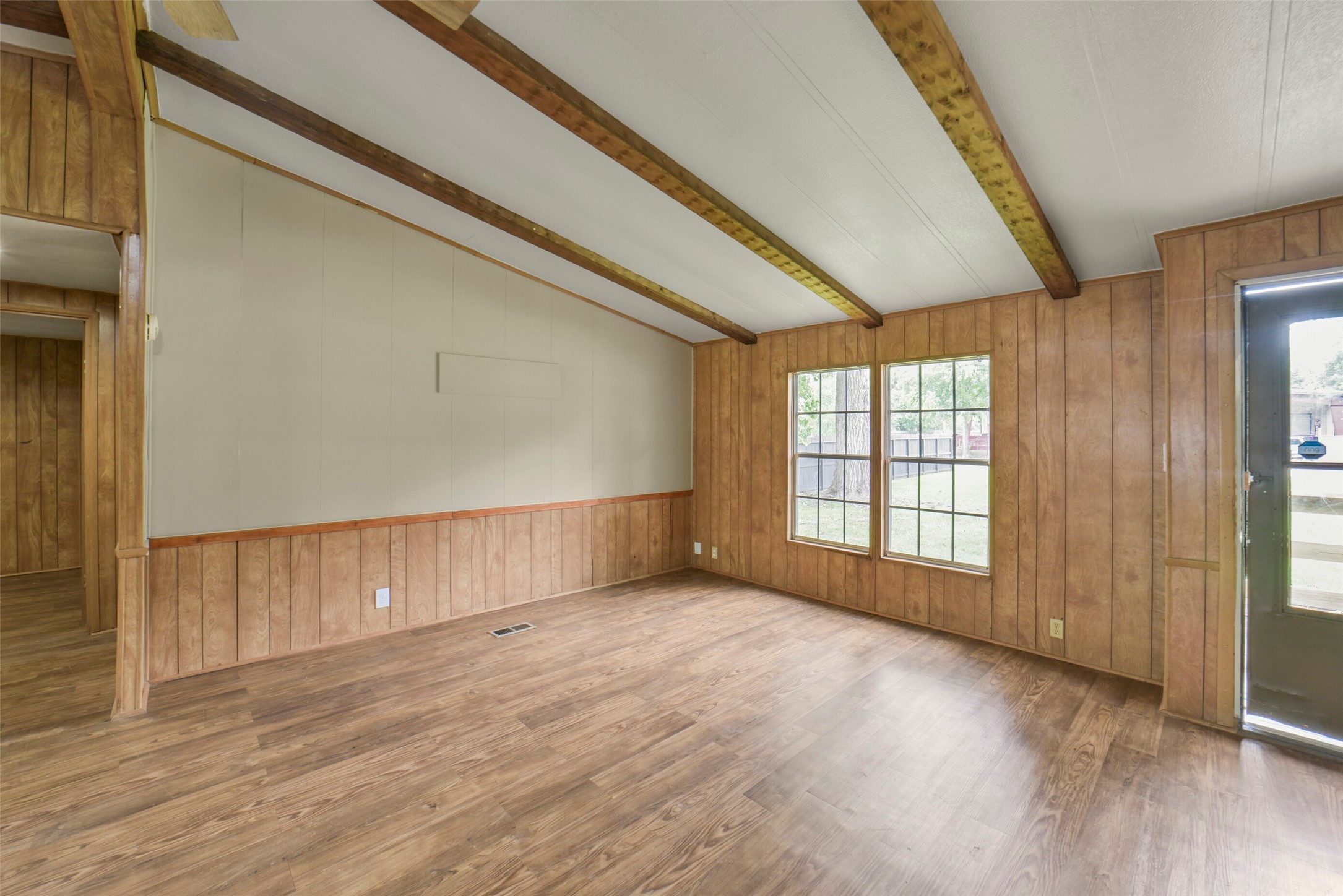 11023 Forrest Valley Drive Houston, TX 77065 - Photo 5 of 47 a view of an empty room with wooden floor and a window