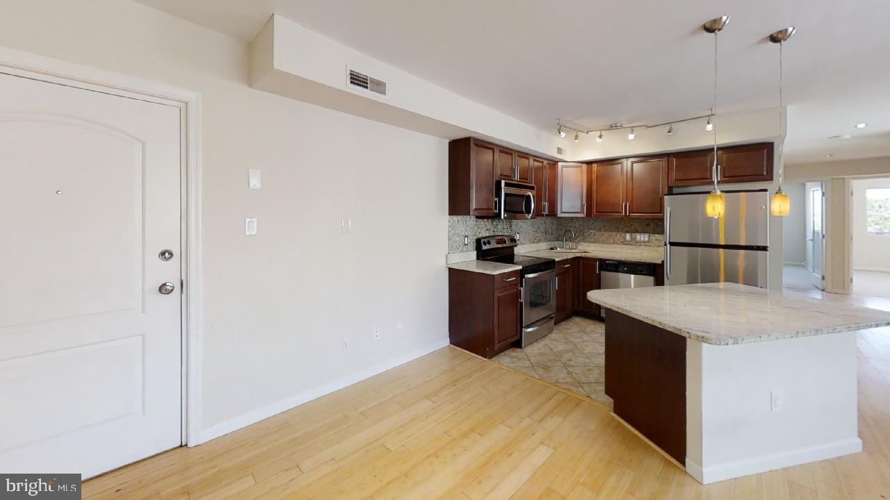 1620 29th Street Southeast, Unit 402 Washington, DC 20020 - Photo 3 of 16 There is a wine cellar on the inside the island