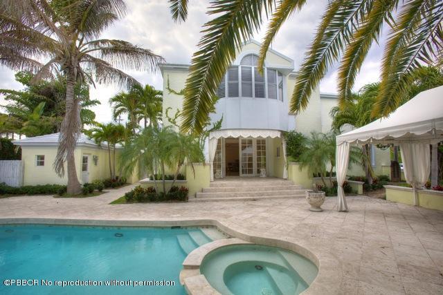 112 Caribbean Road Palm Beach, FL 33480 - Photo 1 of 6 a front view of a house with swimming pool