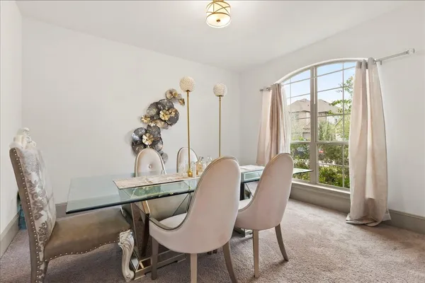 a dining room with furniture and window
