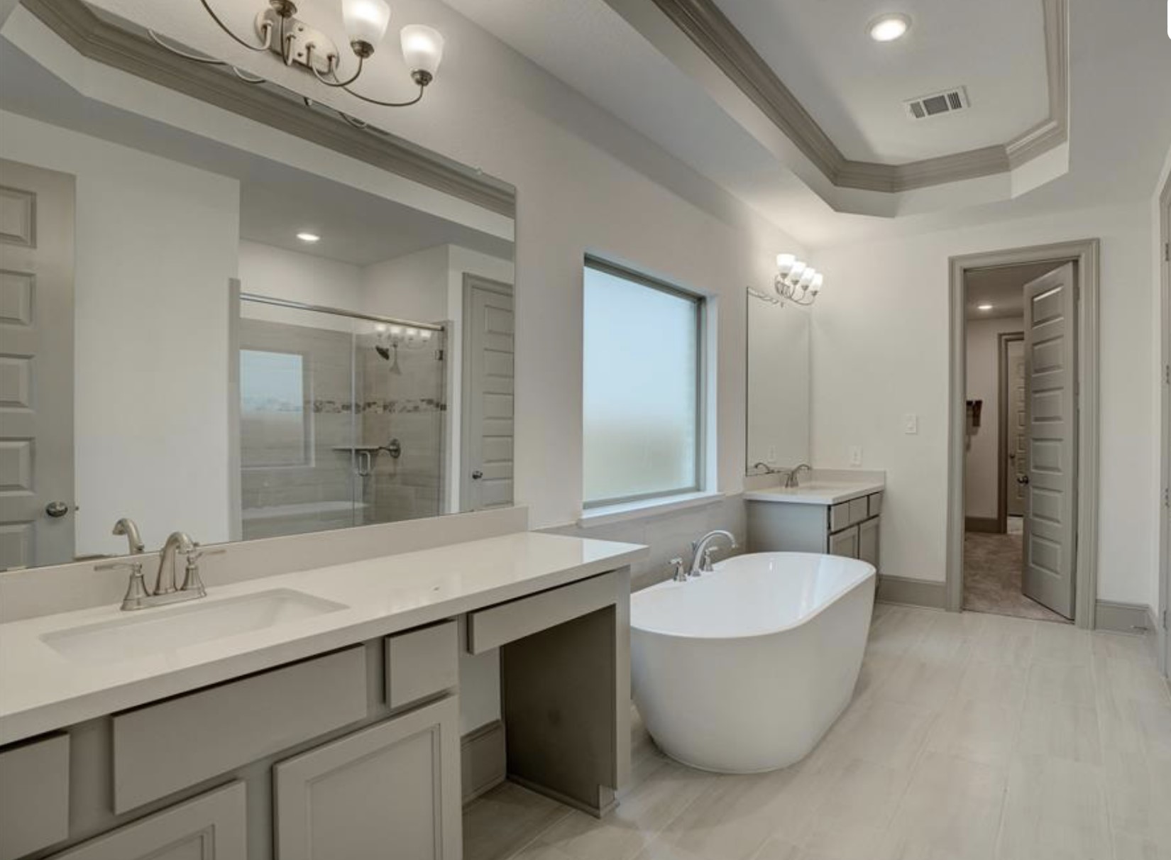 712 Fall Rock Branch Drive Conroe, TX 77304 - Photo 14 of 23 a bathroom with a double vanity sink a mirror and a bathtub
