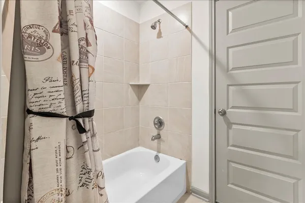 a bathroom with a bathtub and shower