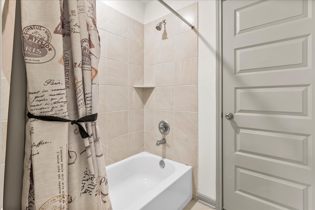 712 Fall Rock Branch Drive Conroe, TX 77304 - Photo 18 of 23 a bathroom with a bathtub and shower