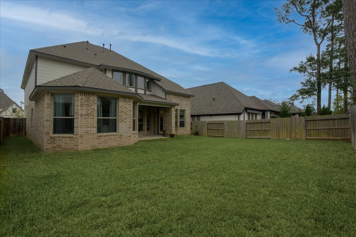 712 Fall Rock Branch Drive Conroe, TX 77304 - Photo 19 of 23 a front view of a house with a garden
