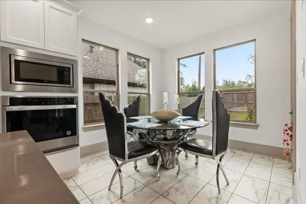 a dining room with furniture a fireplace wooden floor and a rug