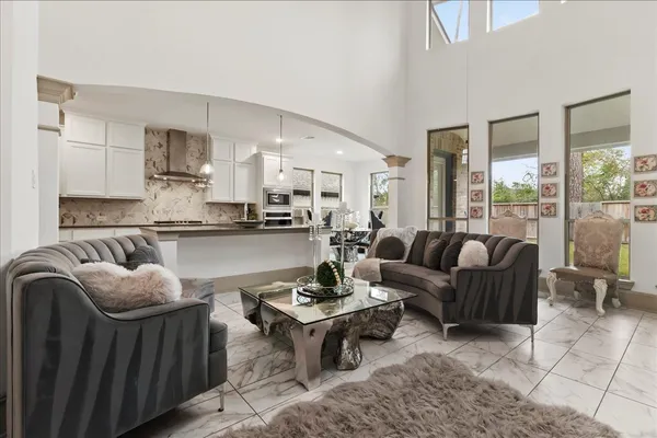 a living room with furniture and a view of kitchen