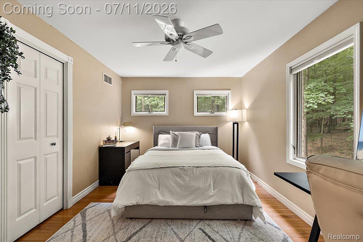 4219 Gardner Road Metamora, MI 48455 - Photo 32 of 87 Room featuring warm-toned walls, wood-finish flooring, a ceiling fan, and multiple windows