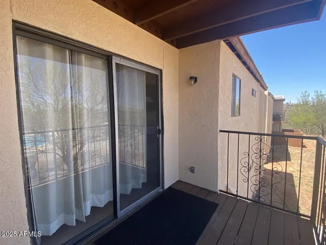 a view of balcony with wooden floor