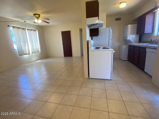 a view of a kitchen with cabinets and stainless steel appliances