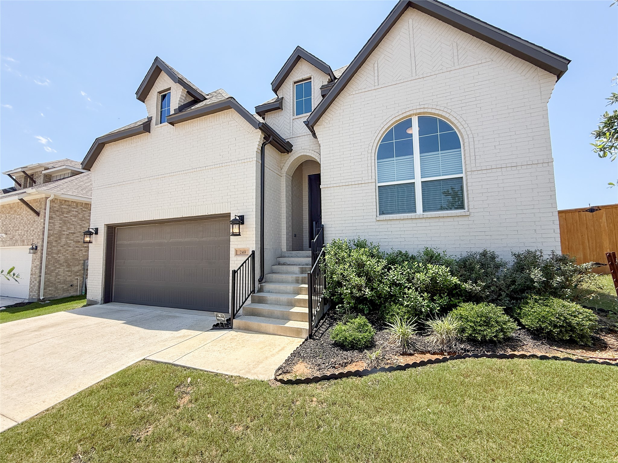 249 Heartleaf Road San Marcos, TX 78666 - Photo 2 of 38 A well-maintained facade features mature landscaping and a practical attached garage.