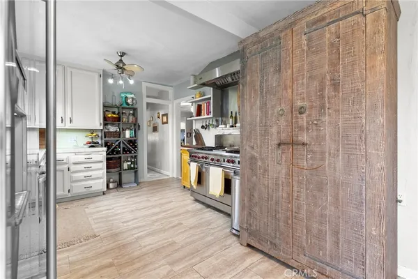 a kitchen with stainless steel appliances a refrigerator and a wooden floor