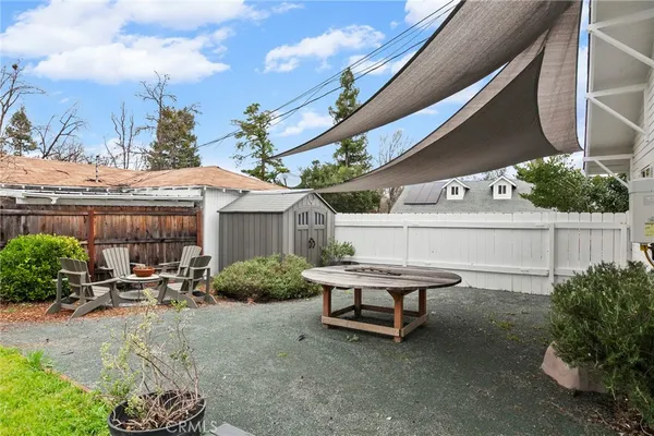 a backyard of a house with yard barbeque oven and outdoor seating
