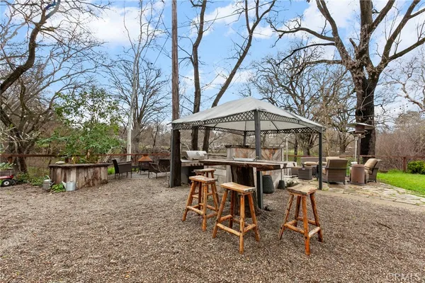 a view of a chairs and table in backyard of the house