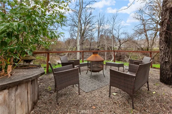 a view of a roof deck with couches and potted plants