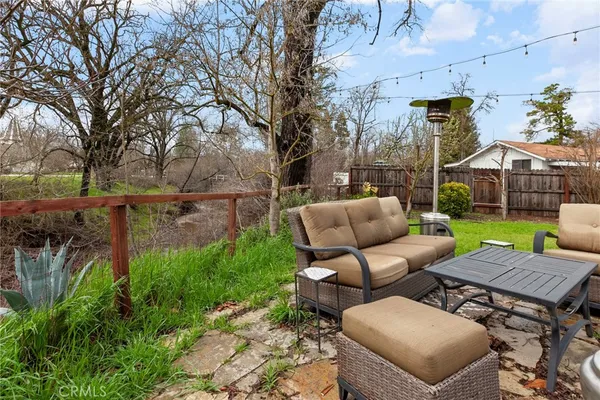 a view of a patio with couches table and chairs and potted plants