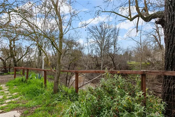 a backyard of a house with lots of green space and plants