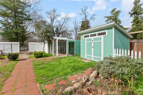 a front view of a house with a yard and potted plants
