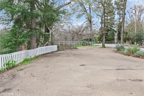 a view of a dirt road with a building in the background