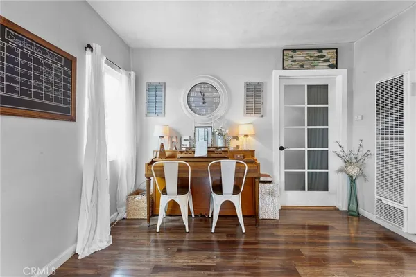 a dining room with furniture and wooden floor