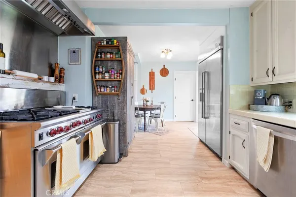 a kitchen with stainless steel appliances a stove and cabinets