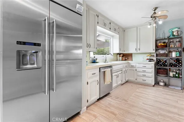 a kitchen with white cabinets and white appliances