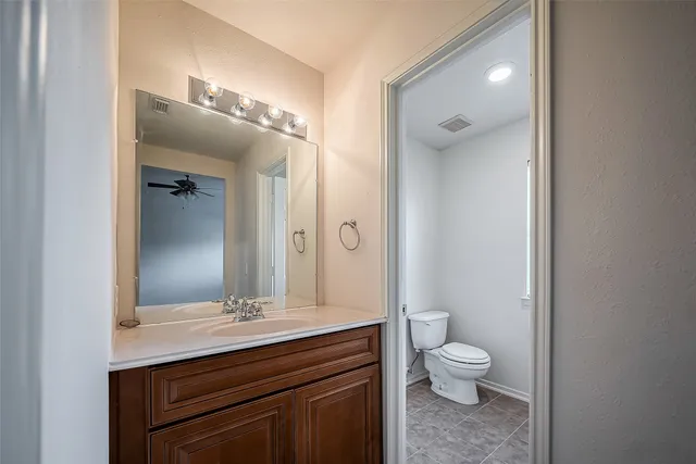 a bathroom with a toilet a sink and mirror