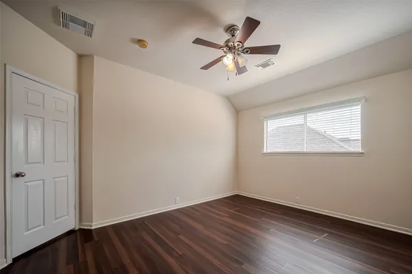 a view of a room with wooden floor and windows