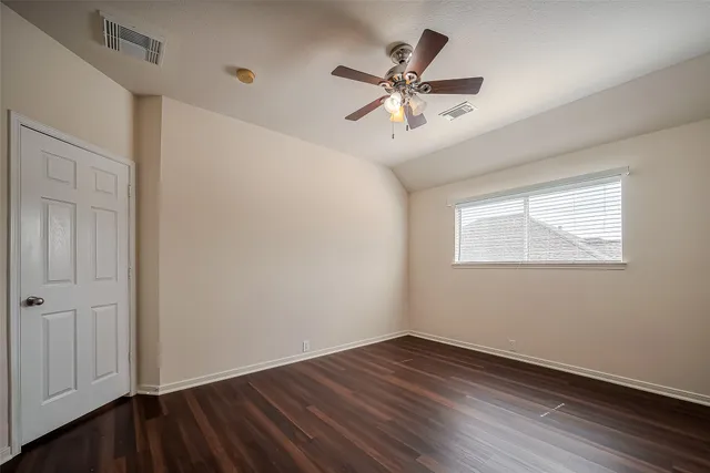a view of a room with wooden floor and windows