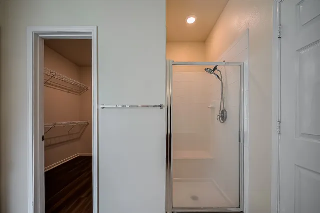 a bathroom with a glass shower door