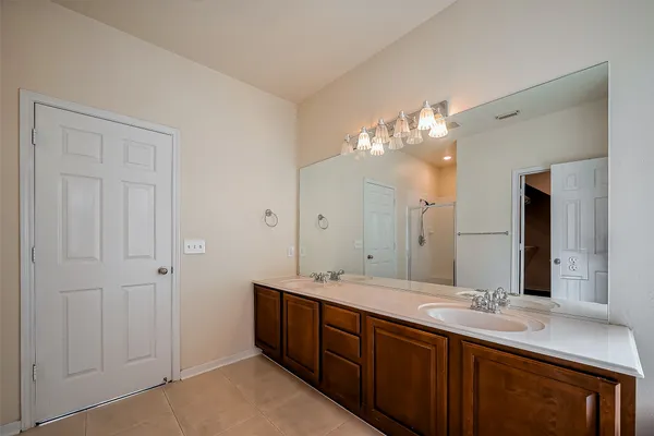 a bathroom with a double vanity sink and a mirror