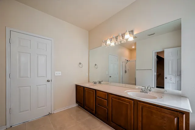 a bathroom with a double vanity sink and a mirror