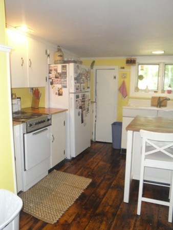 45 Shepard Road Sturbridge, MA 01566 - Photo 3 of 20 a kitchen with stainless steel appliances granite countertop a refrigerator a stove and white cabinets with wooden floor