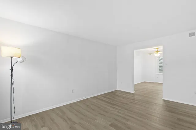 a view of an empty room with wooden floor