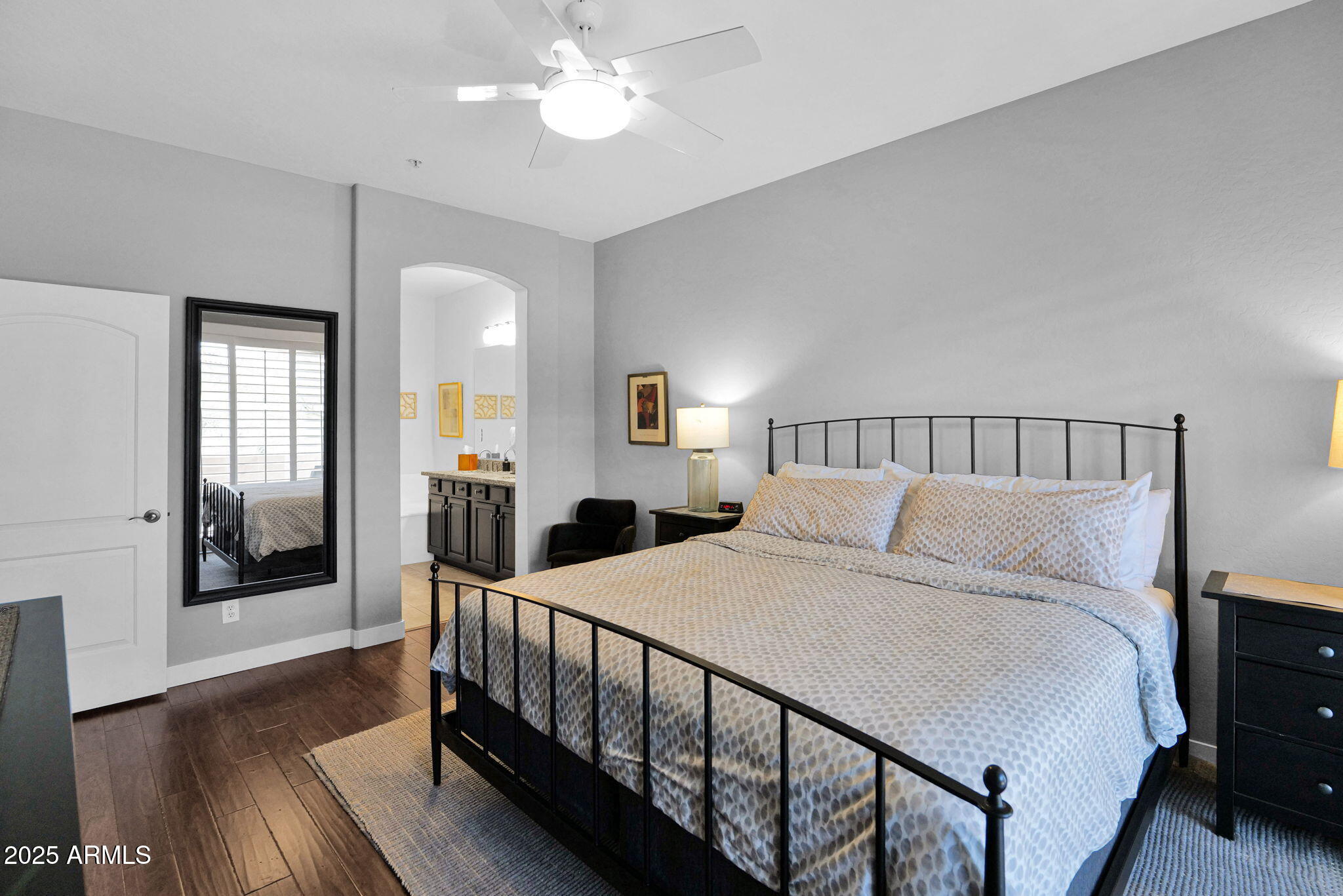 19550 North Grayhawk Drive, Unit 1063 Scottsdale, AZ 85255 - Photo 14 of 40 a bedroom with a large bed and a chandelier