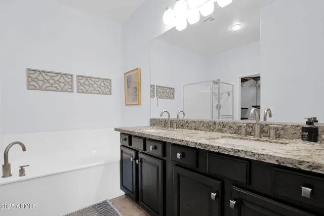 a bathroom with a granite countertop sink a large mirror and vanity