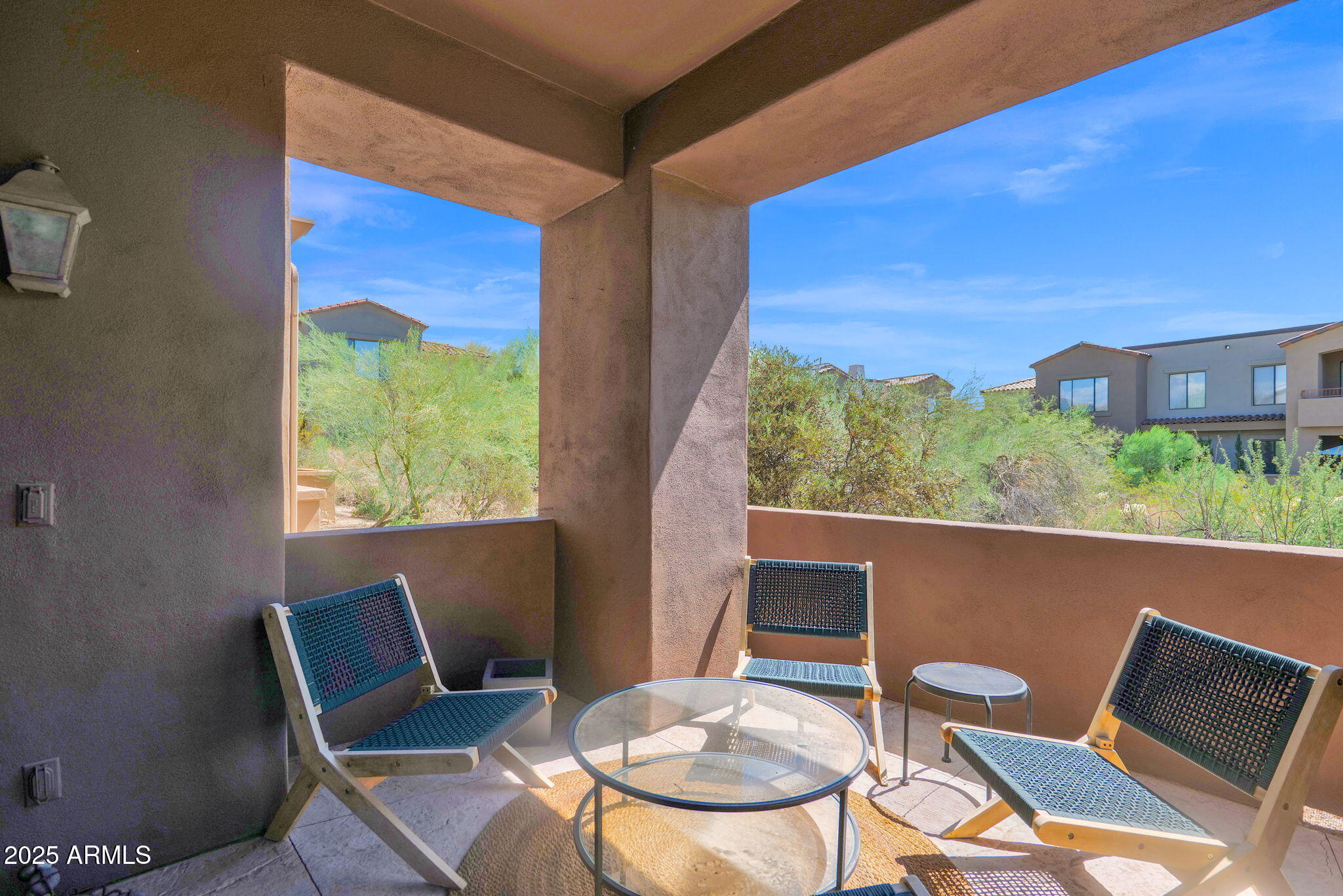 19550 North Grayhawk Drive, Unit 1063 Scottsdale, AZ 85255 - Photo 20 of 40 a balcony with table and chairs