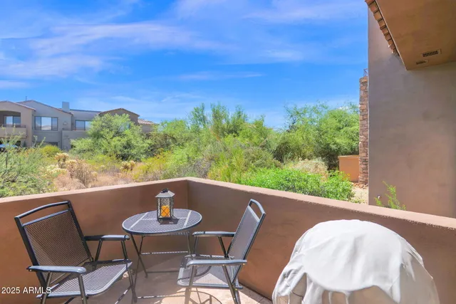 a view of a chairs and table in patio
