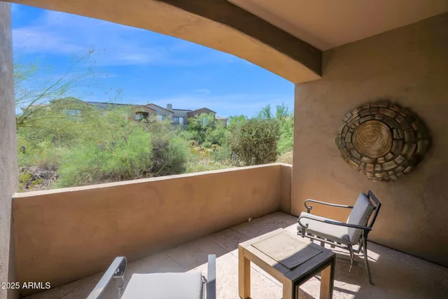 a view of a chairs and table in a balcony