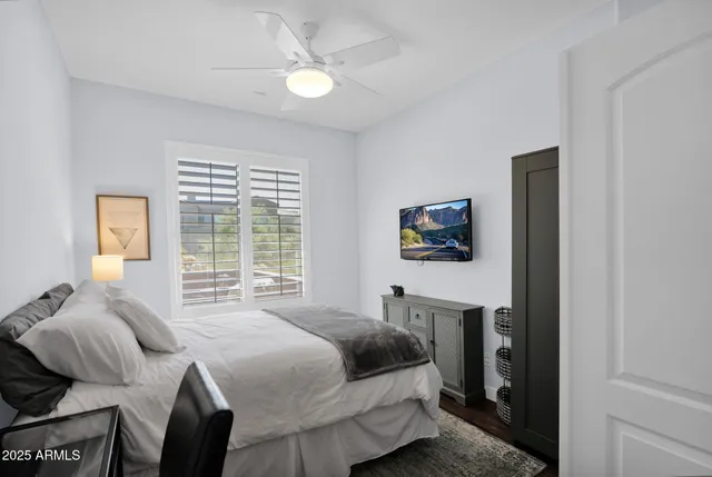 a bedroom with a bed and a chandelier